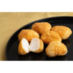 Close-up of Funwari Meijin Mochi Puffs Snack Kinako Flavor, 75g, featuring airy rice puffs for a unique texture experience.